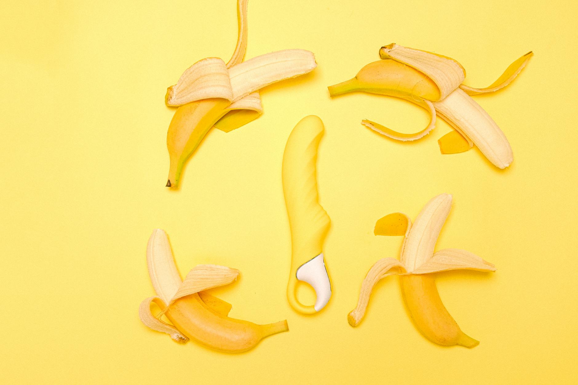 Yellow silicone lemon vibrator on soft background